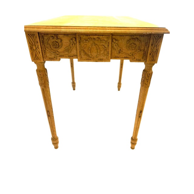 A lovely French Louis XVI bleached oak side table on tapered fluted legs with a carved apron of neoclassical design—Laurel...