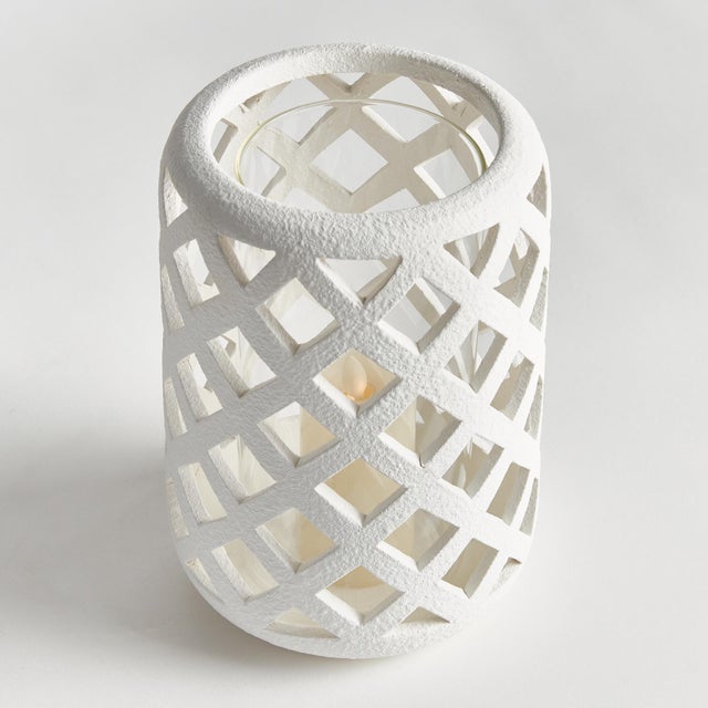 Expertly crafted from hand cut ceramic strips, and finished in a brightWhite glaze, this hurricane lets all the light...