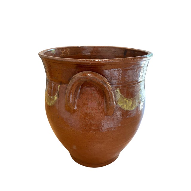 Steeped in rustic charm, this antique hand-thrown terracotta pitcher pot brings warmth and character to any space....