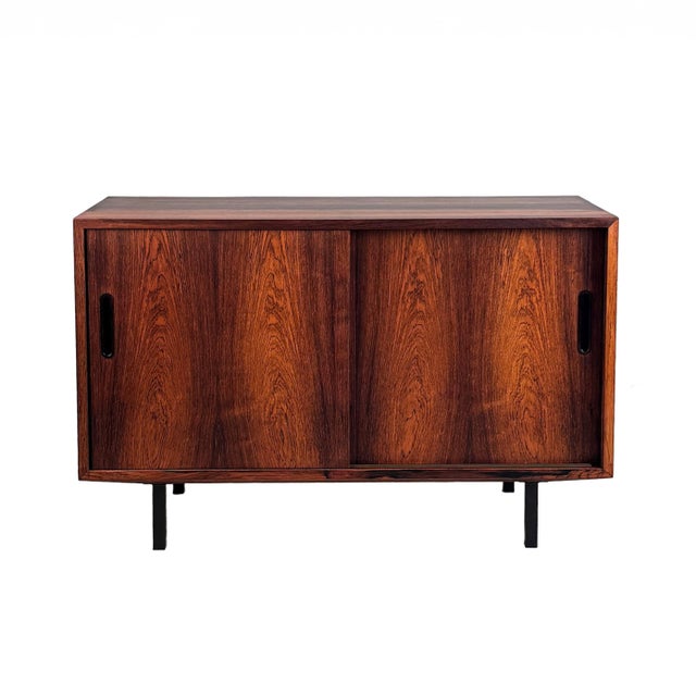 Beautiful vintage sideboard crafted in Brazilian rosewood with sliding doors and a stunning grain detail enhancing the...