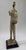 This mid-century modern sculpture depicts a stylized musician playing an accordion, rendered in an elongated and...