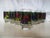 Colorful set of seven Libbey footed tumblers featuring a stained glass design raised fruit-motif around perimeter. Marked...