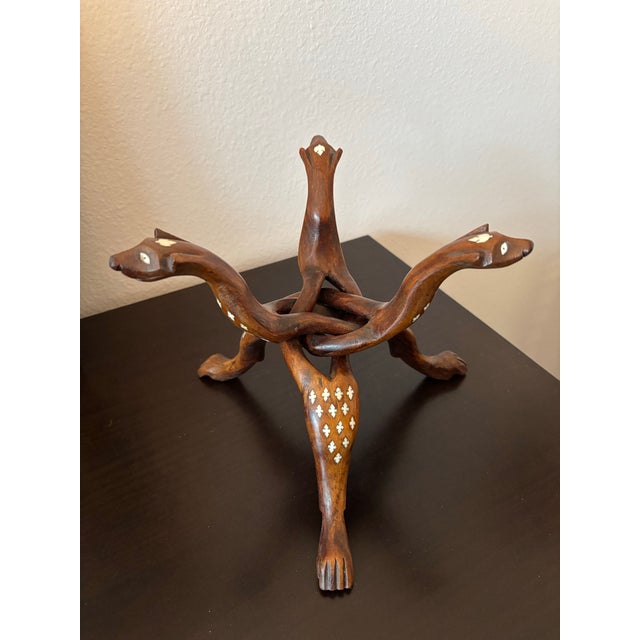 Exceptional 1930s Hand‑Carved Rosewood Snake Tripod Stand with Bone Inlay and Detailed Serpent Heads A rare and...