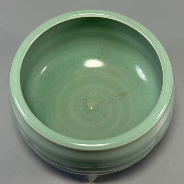 This antique Chinese Longquan celadon tripod censer stands on three short feet, decorated with traditional Bagua pattern...