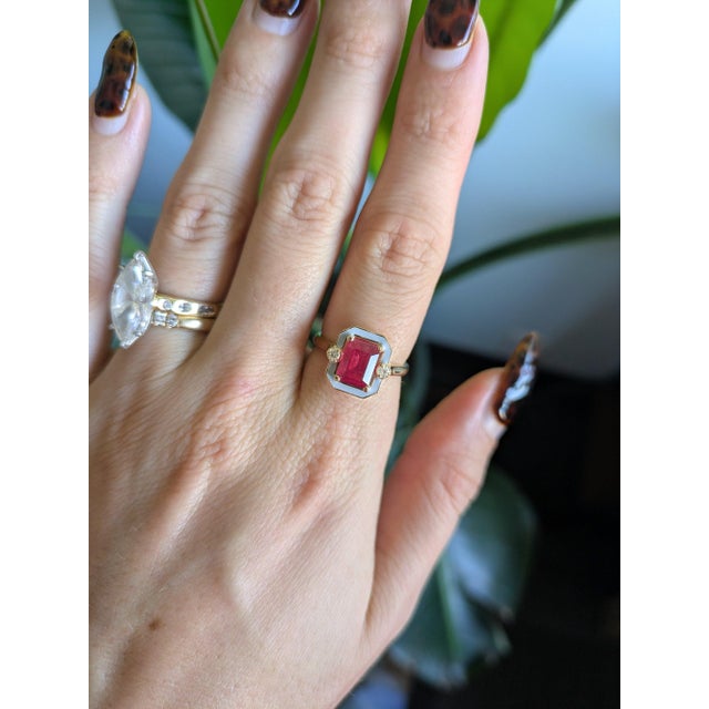 Made for game day in Columbus, this ring centres a 2.23-carat scarlet ruby in solid 14K yellow gold and sets two earth-...