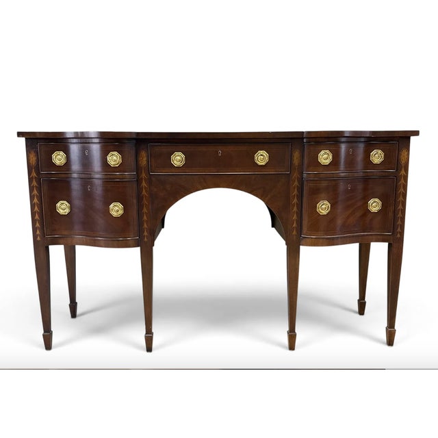 Federal style mahogany sideboard by E.J. Victor featuring a serpentine front with banded and inlaid detailing. The...