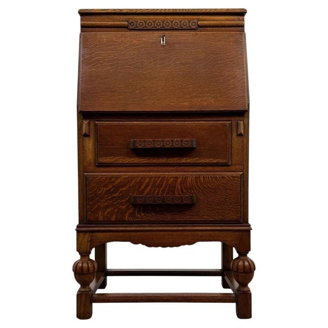 An unusual early 20th-century English bureau, finely crafted from golden oak and distinguished by its ingenious fitted...