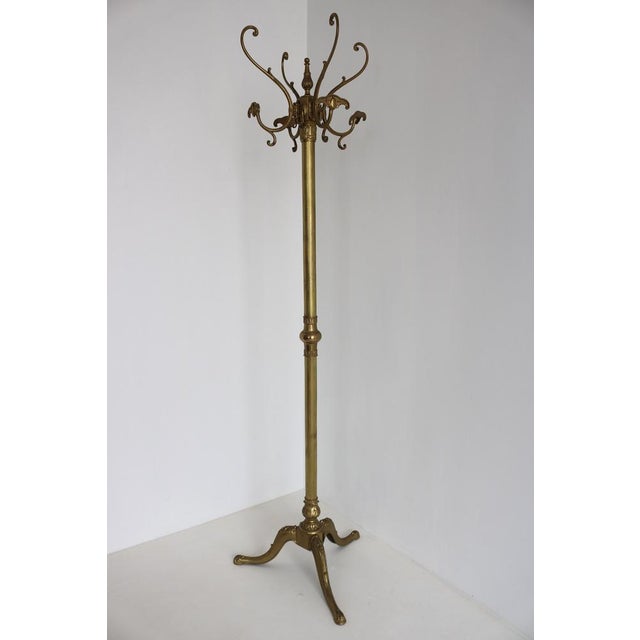 Elegant Italian brass coat rack dating from the 1960s, featuring a beautifully detailed rotating crown, decorative hooks,...