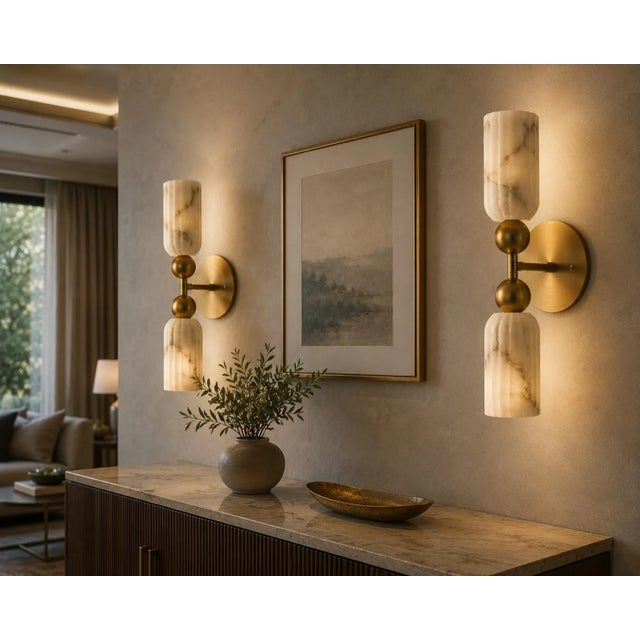 Crafted from solid brass and genuine natural alabaster, this handcrafted wall sconce combines refined materials with a...