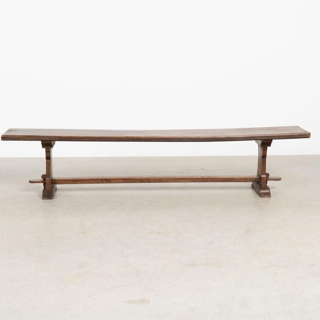 Early 20th century French bench with a simple trestle base and clean, understated lines. The chestnut wood has developed a...