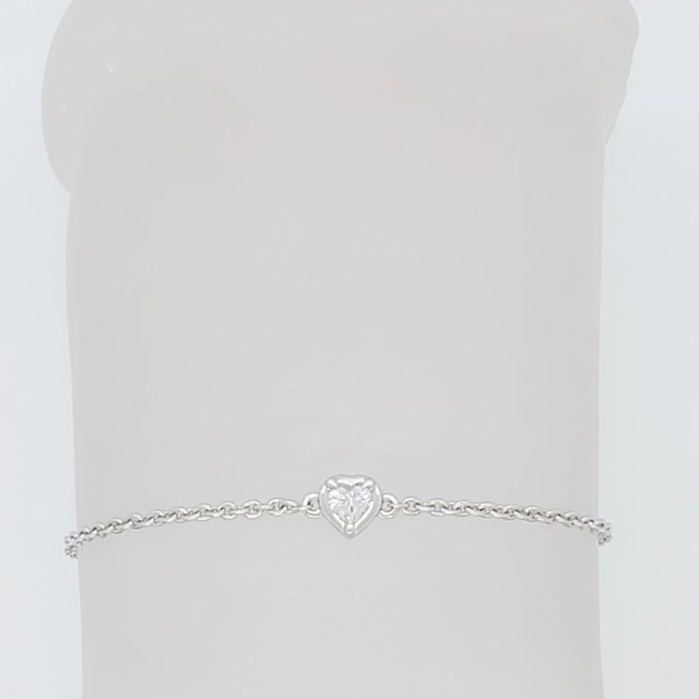 Beautiful and simple 0.15 ct. heart cut white diamond bezel set with 18k white gold chain. Length is 7.25. Metal: White...