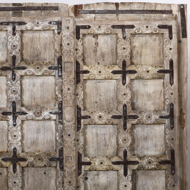 This outstanding door from Gujarat, c. 1880-1900, of 16 small panels per side, has beautiful carved moldings around each...