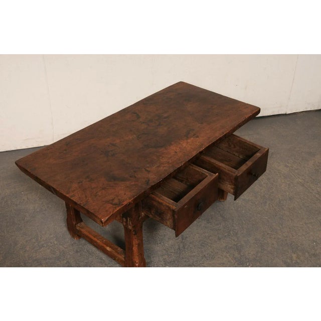 A Spanish wooden coffee table with drawers, from the turn of the 18th and 19th century. This antique wooden table from...