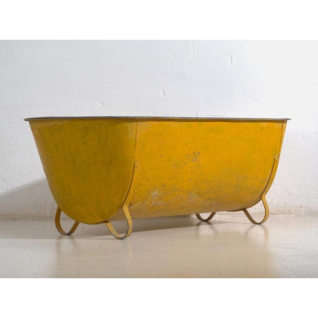 Rustic galvanized-metal container, most likely an outdoor trough or agricultural storage vessel, originally from central...