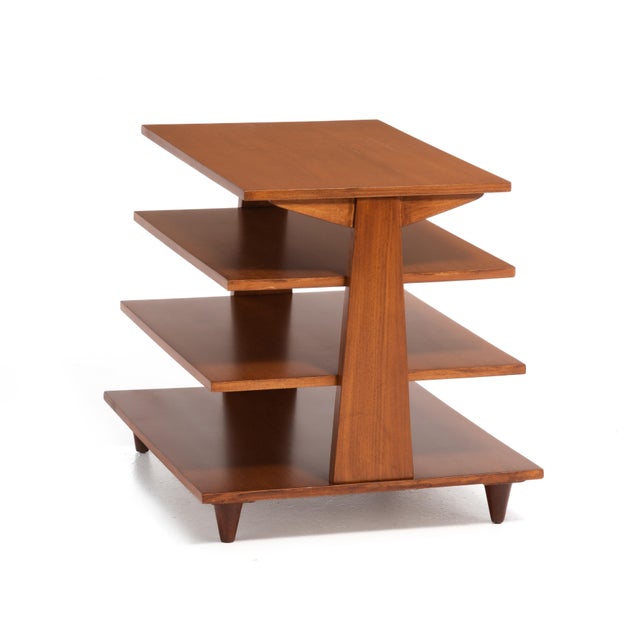 A Mid Century magazine tree in the style of the iconic Edward Wormley for Dunbar model 4765. This piece features four...