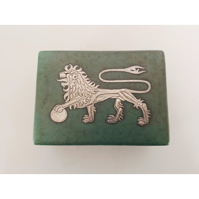 Lidded stoneware box designed by renowned Swedish artist Wilhelm Kåge for Gustavsberg in 1932. The box features a rich...