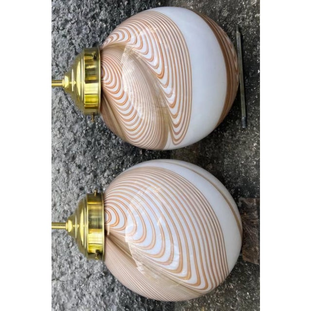 Rare matching pair of mid-century Italian lamps designed by Dino Martens for Toso. Hand-blown Murano glass spherical...