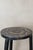 Vintage Ethiopian coffee table, characterized by its rustic wooden construction, two-tiered design, and a striking top...