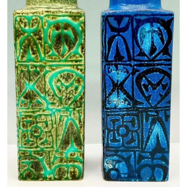A set of two Danish Modern square vases, one green and one blue. The highly collectable vases are an example of the "Baca"...