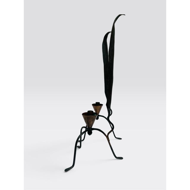 Minimalist vintage black forged wrought iron and copper candleholders. The sleek tall pair also has carving details on the...
