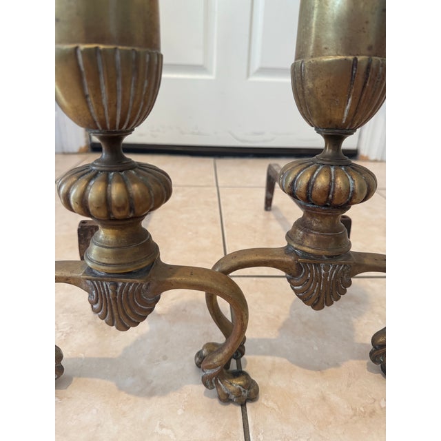 The pair features curved, scroll-style legs with lion's paw feet and a fluted urn-and-column design Ornate fronts are...
