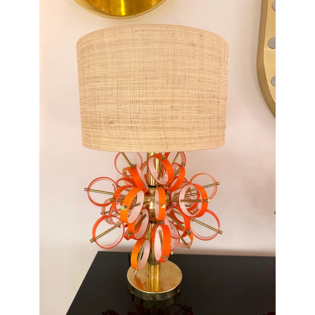 Pair of table or bedside brass sputnik lamps with orange and white Murano glass rings. Contemporary work from a small...