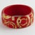 This stunning Salvatore Ferragamo, Italy bracelet features a chunky Lucite or acrylic bangle in luminous red color, ornate...