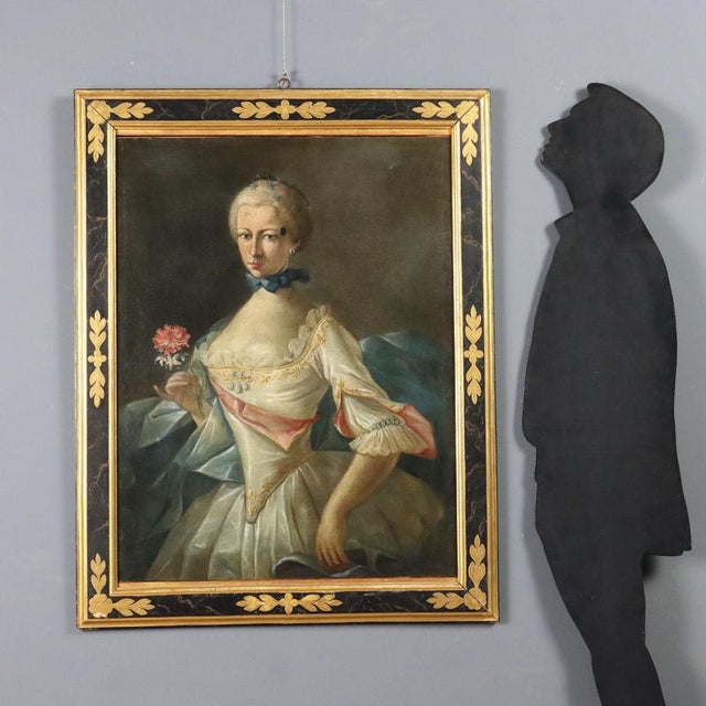 Oil on canvas. Northern Italian School, 18th century. The elegant lady, wearing a dress embellished with pearls and satin,...