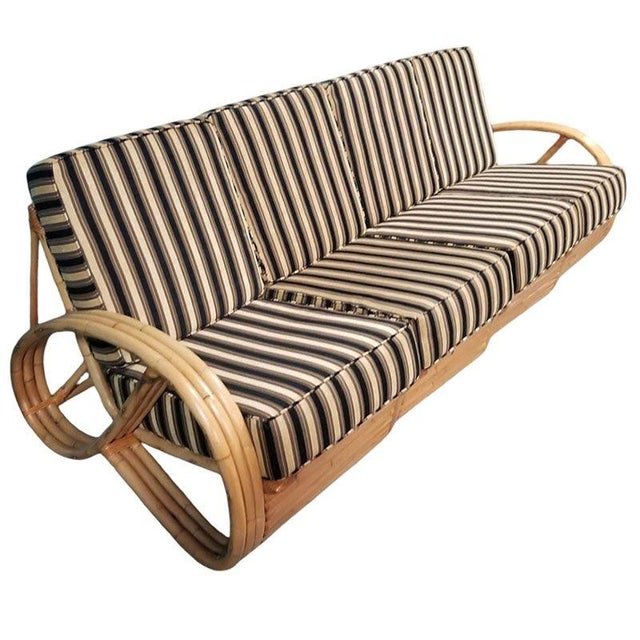 This beautifully restored Mid-century 2-piece living room set featuring a 3/4 pretzel arm rattan sectional 4-seat sofa...