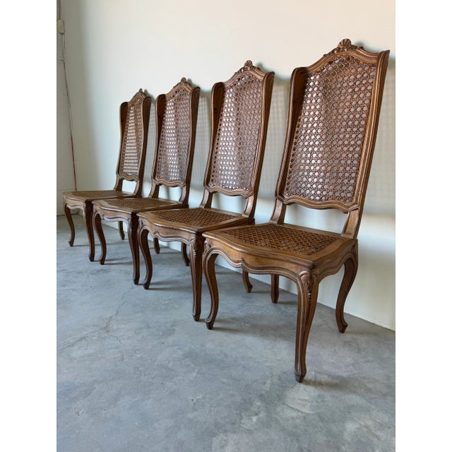 This elegant set of four vintage French Country Louis XV–style dining chairs showcases timeless craftsmanship and romantic...