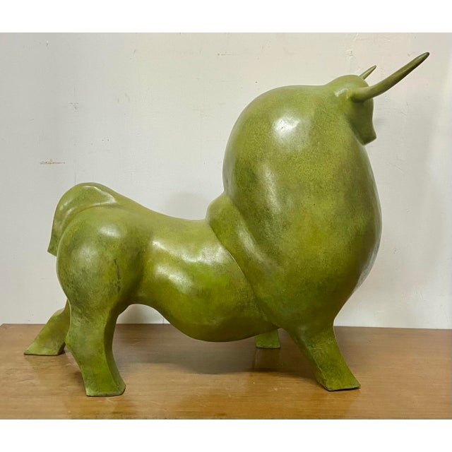 Monumental abstract bronze bull sculpture with green patina, inspired by the iconic rounded forms associated with Fernando...