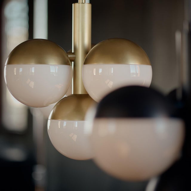 Suspended like droplets of light, the milk glass orbs of the Oliver Pendant create a sculptural focal point that is sure...