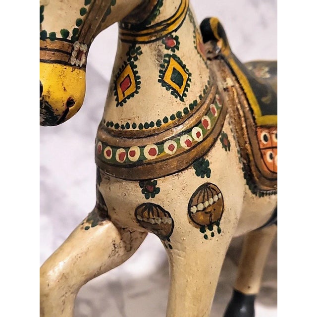 Beautiflully carved wedding horse representing strength and fertility. Handpainted accents. Made in India.