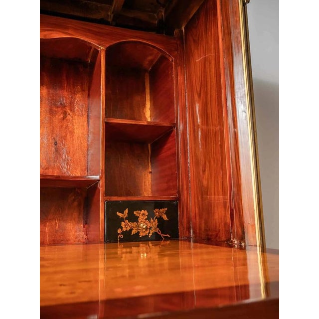 Secretary with a hinged top and a marble top in the classicist style. The top marble top made of green French marble is...