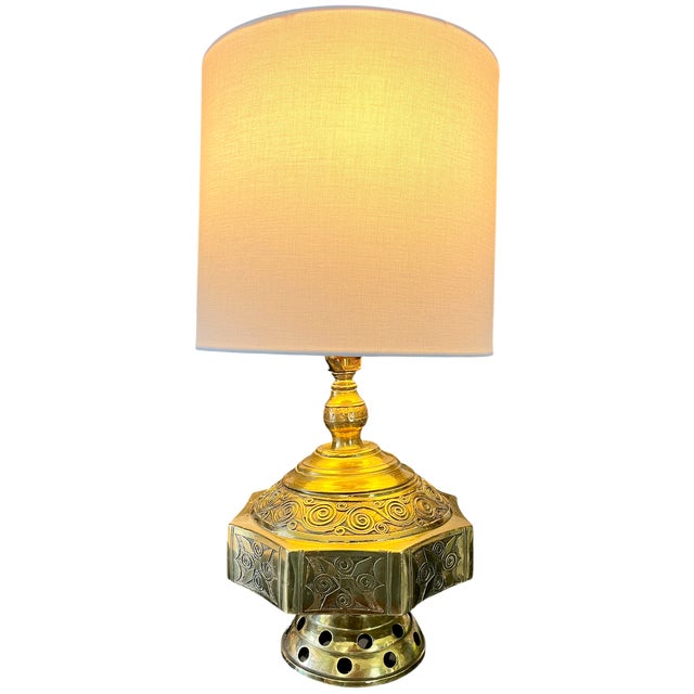 Striking mid-century brass table lamp with an unusual form inspired by traditional Moroccan oil lamps and lanterns. The...