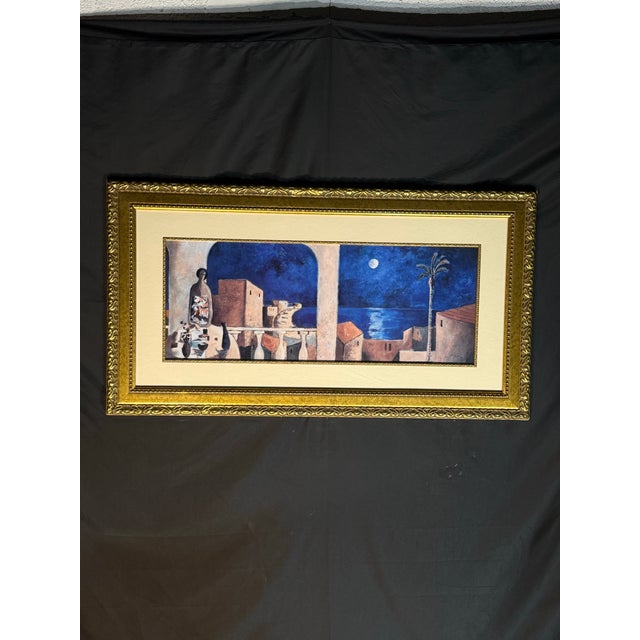 A Mediterranean coastal-style framed wall art piece featuring a dramatic night scene with deep blue tones, moonlight,...