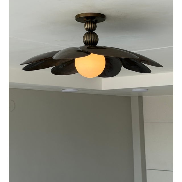 Add timeless character and artistic elegance to your interior with this handmade black antique brass semi-flush mount...