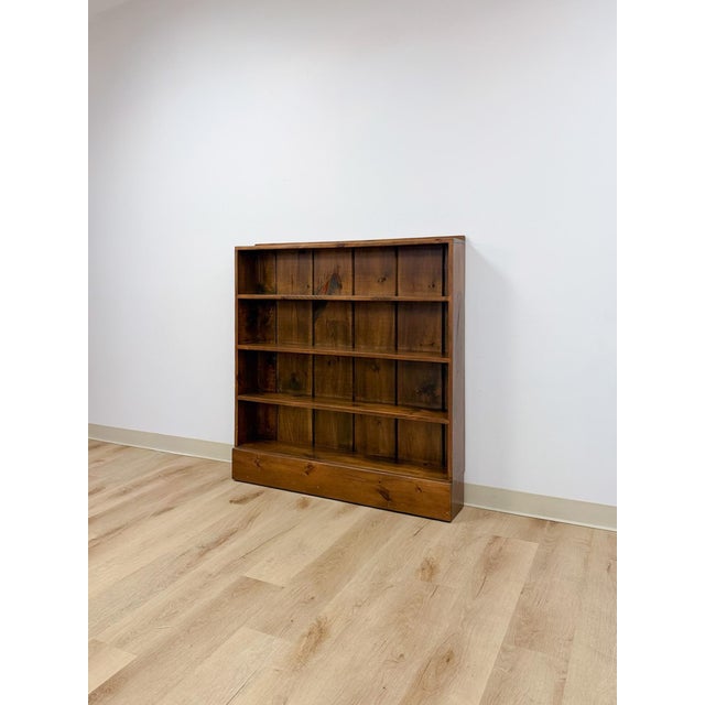 This clean and well-made vintage MCM solid walnut four shelf bookcase is a practical and handsome mid-century modern...