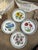 This is a set of four ceramic plates featuring exquisite floral patterns. These plates are a wonderful way to add color...