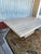 Elegant dining table is made of solid travertine stone. The piece has a natural beige and cream color palette with a...