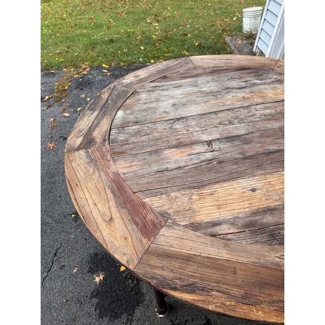 Reclaimed solid elm and cast iron table. Full of cracks, knots and patina. Each table is unique as the boards are salvaged...