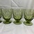 Offered here are mid-century Fostoria Mesa Olive Green footed juice/wine glasses, which feature a signature pressed...