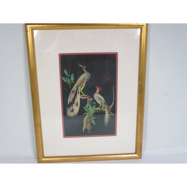 This vintage hand-painted artwork depicts a colorful peacock and pheasant perched on tree branches. The birds are accented...