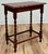 Antique English oak side table with deep red stain, pie crust top and four classic barley twist legs attached by four box...