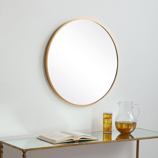This 34" round mirror, made of aluminum, is finished in a brushed gold. Whether you are updating a foyer or a bathroom,...