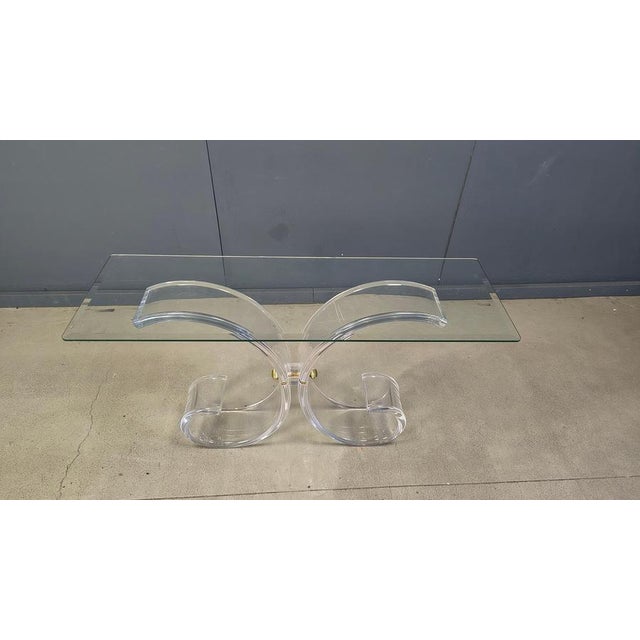 Remarkable console table with a brass and acrylic glass frame and a glass top. Attributed to Charles Hollis Jones. Very...