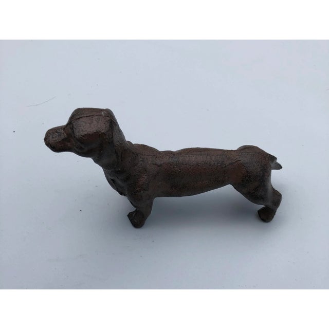 Very sturdy iron dachshund statue in majestic stance. Great tabletop decoration. Could be dependable paperweight. 3.75”...