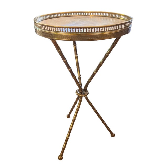 This stylish pair of side tables were made in France in the 1950s. with solid marble tops and brass galleries these pieces...