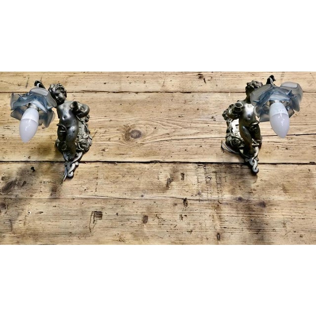 A Pair of Pretty French Arts and Crafts Cherub Wall Lights These are very pretty pieces, the lights are made in a pewter...