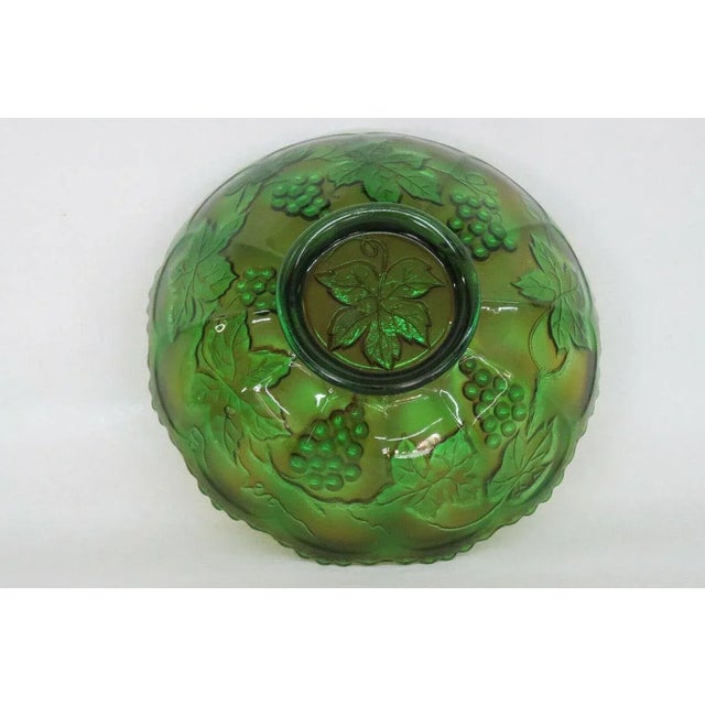This gorgeous carnival glass bowl has a brilliant iridescent green color, and is made in the fabulous style of Grape Vine...